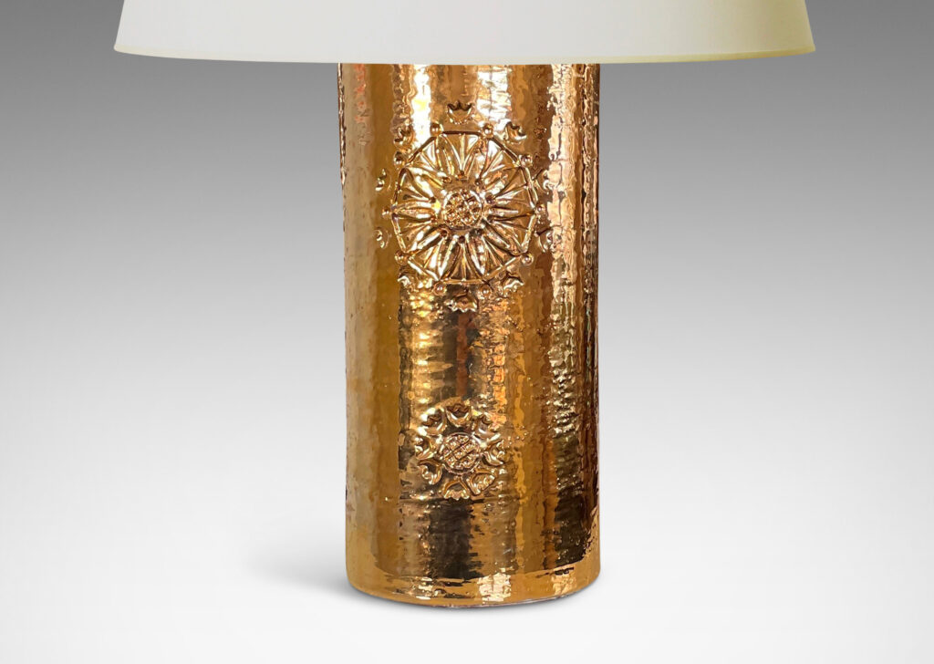 Gallery BAC canister forms with intaglio medallion motifs and thick gold luster glaze