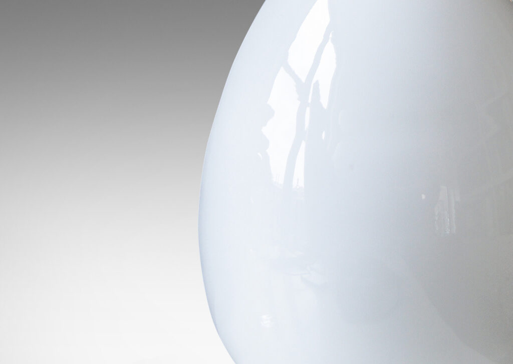 Gallery BAC egg-like forms in white opaline glass mounted to steel stands and bases