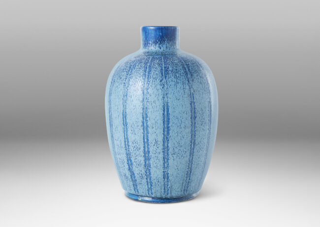 Gallery BAC upright ovoid form with carved meridians, crafted in earthenware with a wonderful two-tone blue glaze