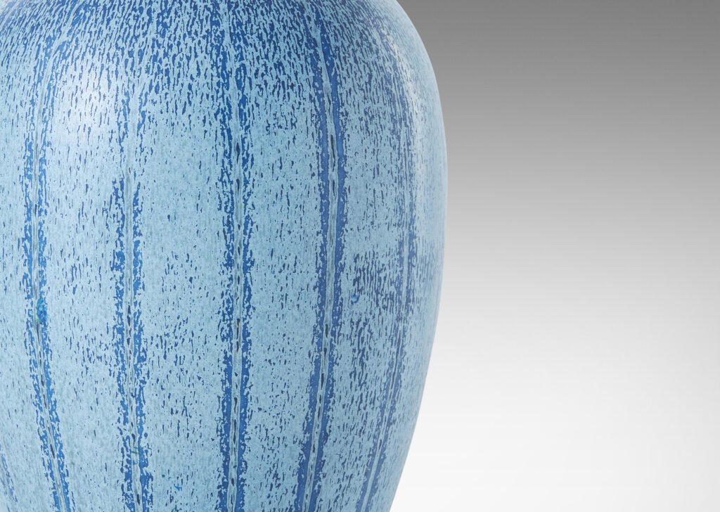 Gallery BAC upright ovoid form with carved meridians, crafted in earthenware with a wonderful two-tone blue glaze