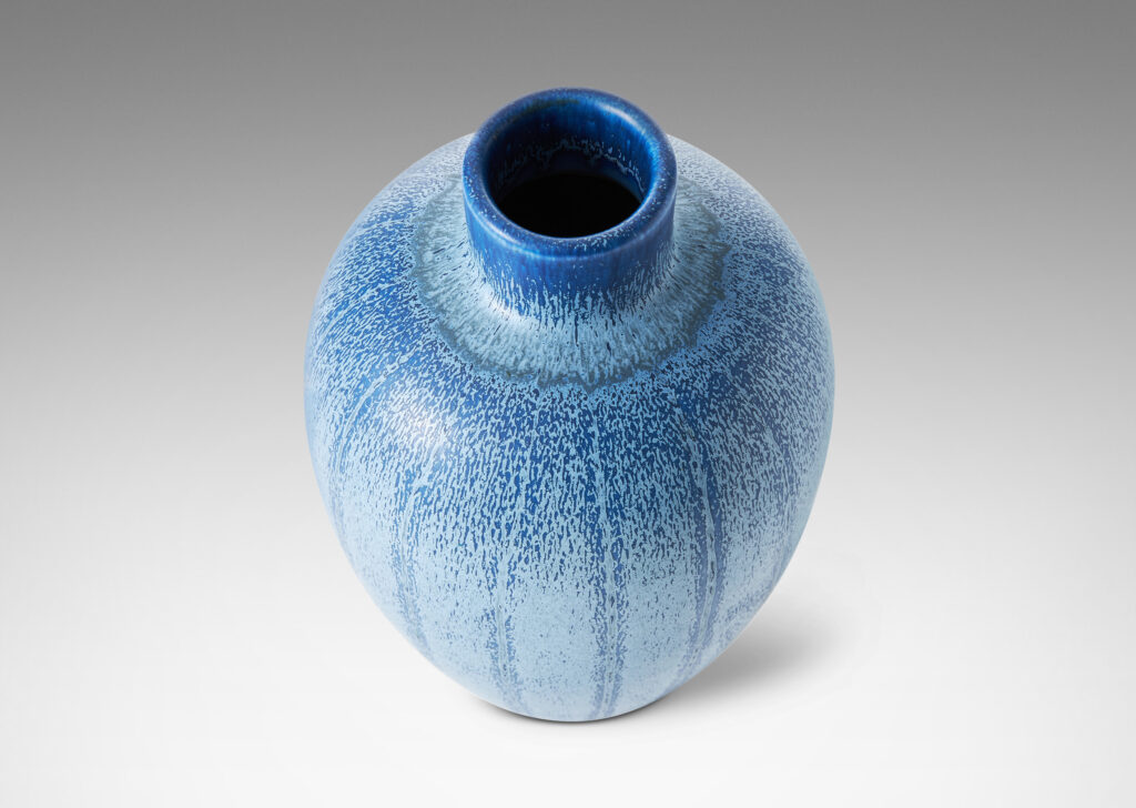 Gallery BAC upright ovoid form with carved meridians, crafted in earthenware with a wonderful two-tone blue glaze