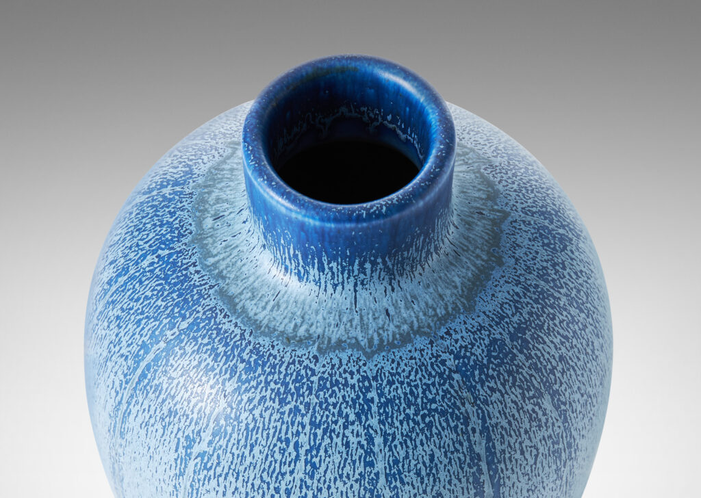 Gallery BAC upright ovoid form with carved meridians, crafted in earthenware with a wonderful two-tone blue glaze