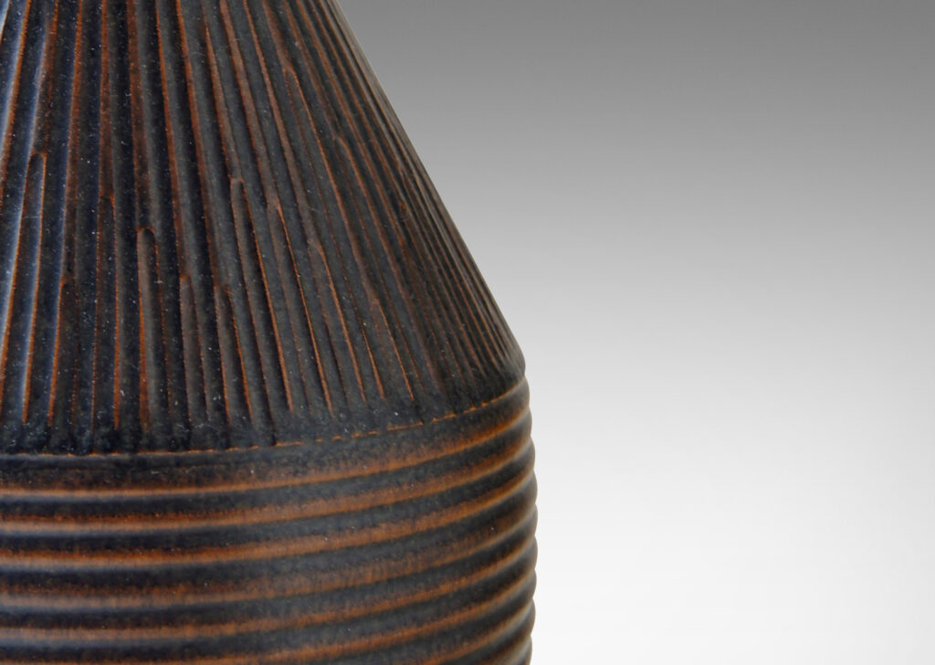 Gallery BAC drum form with conical top covered in a rattan-like reeded texture