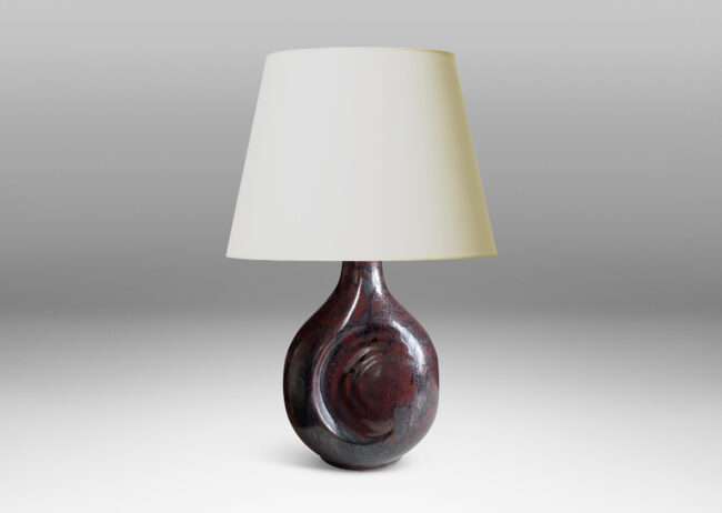 Gallery BAC sculptural bulbous form with round inset design in a burgundy/oxblood-gunmetal luster glaze