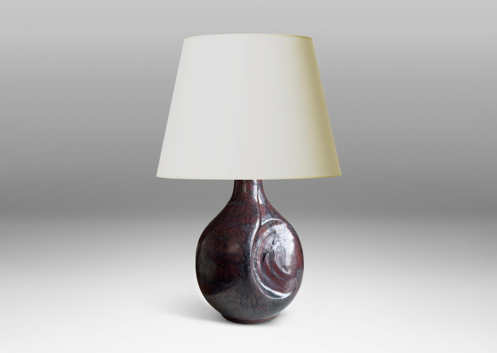 Gallery BAC sculptural bulbous form with round inset design in a burgundy/oxblood-gunmetal luster glaze