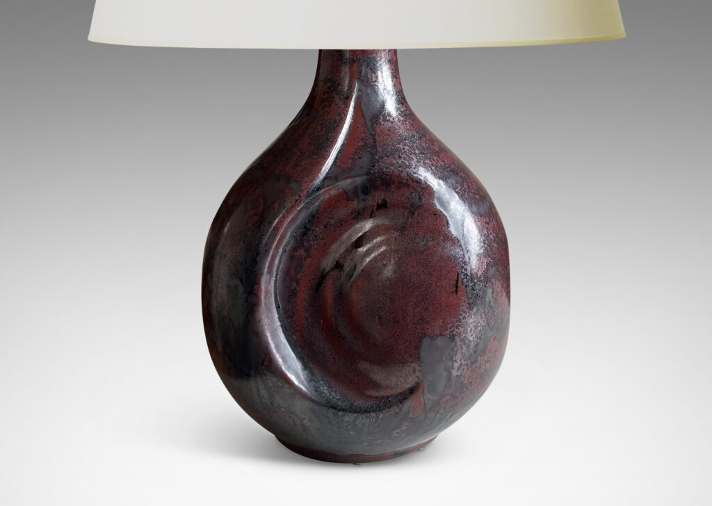 Gallery BAC sculptural bulbous form with round inset design in a burgundy/oxblood-gunmetal luster glaze