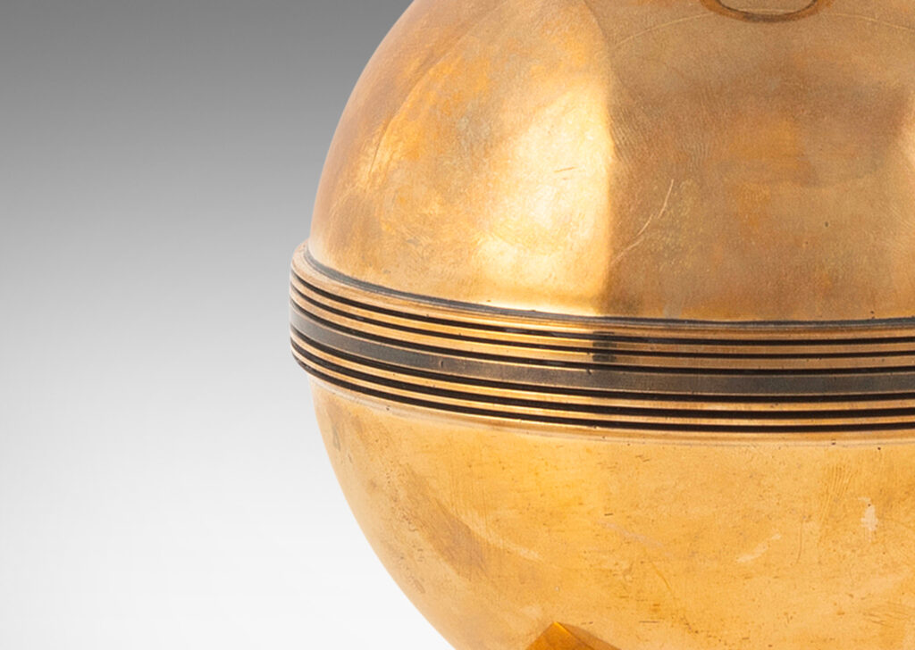 Gallery BAC globe form on a square plinth, with engraved and patinated band