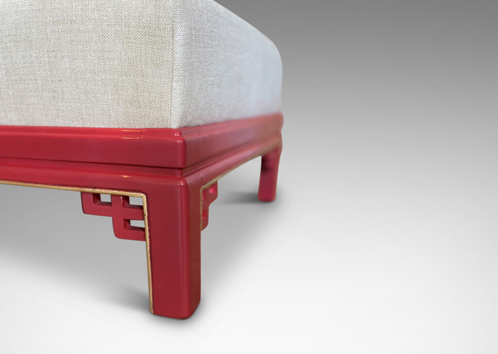 Gallery BAC scrolling back and bracketed legs finished in vermillion lacquer with gilded detailing and newly reupholstered in a pale gold chenille