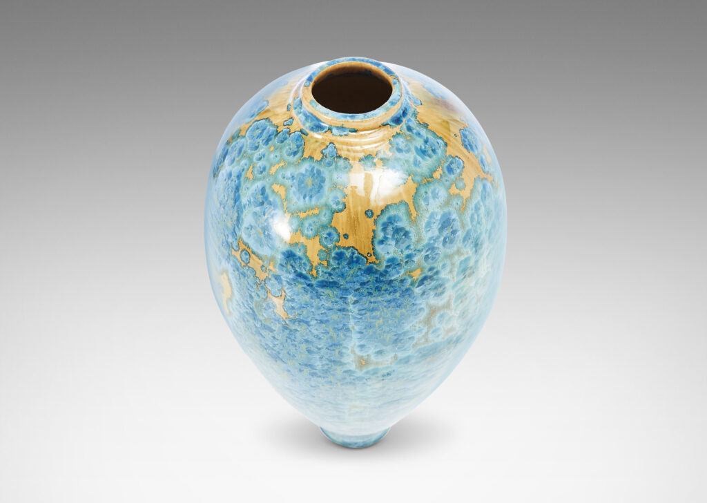 Gallery BAC tapering form glazed in a magnificent gold and cerulean crystalline glaze