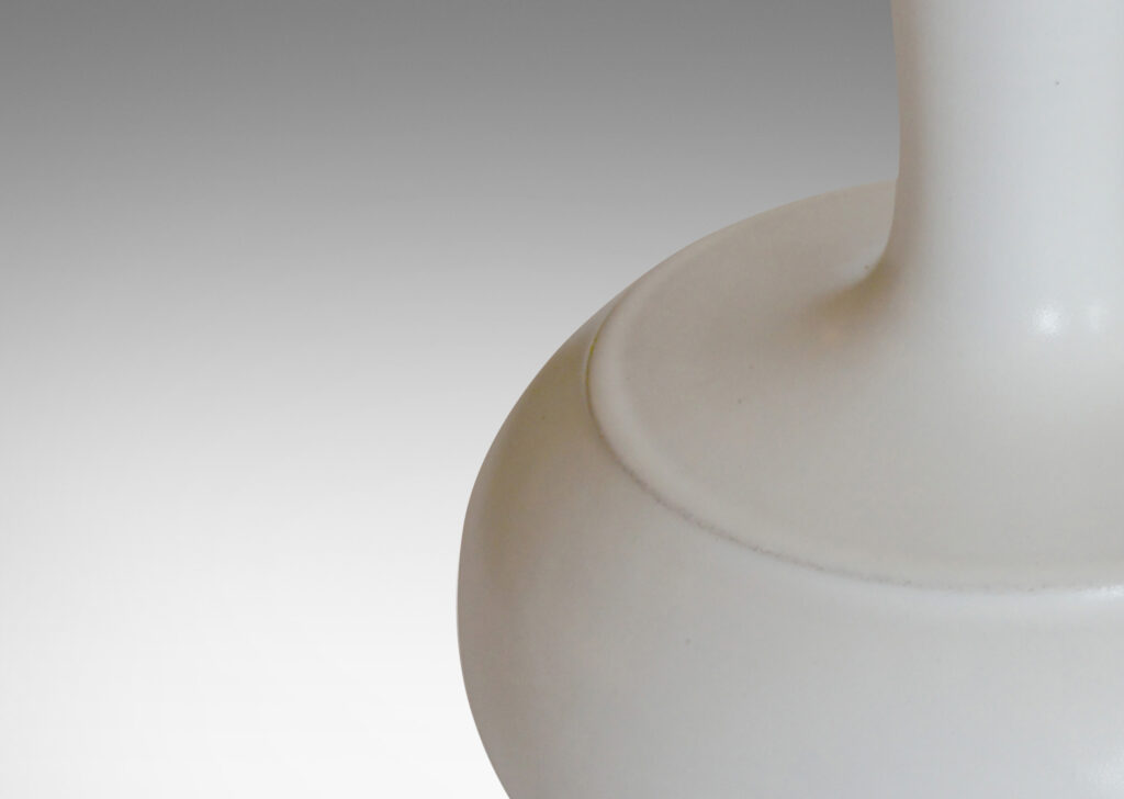 Gallery BAC spherical bodies with attenuated necks, crafted in earthenware with a satiny white glaze