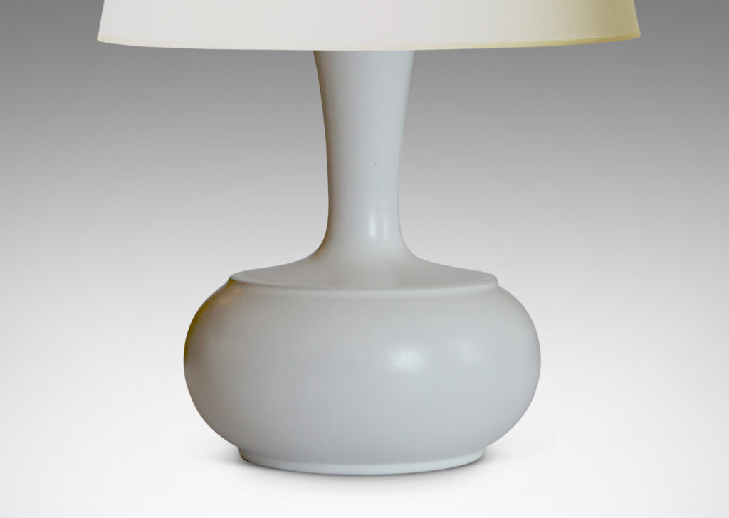 Gallery BAC spherical bodies with attenuated necks, crafted in earthenware with a satiny white glaze