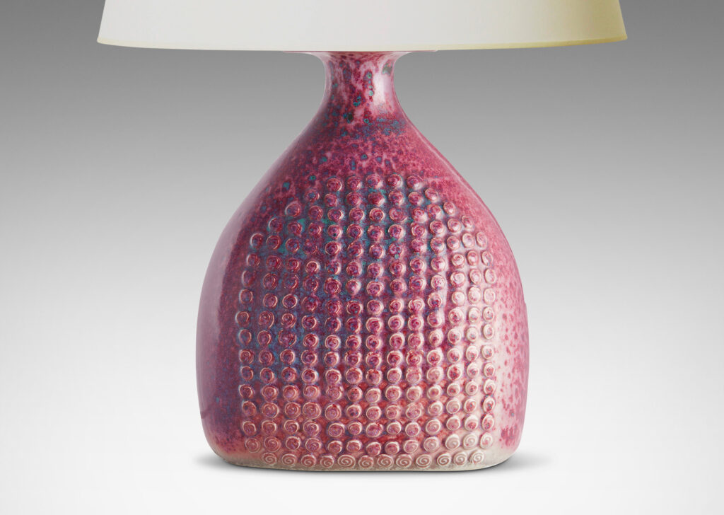 Gallery BAC bottle form with knob texture on front and back and a magnificent mottled raspberry glaze