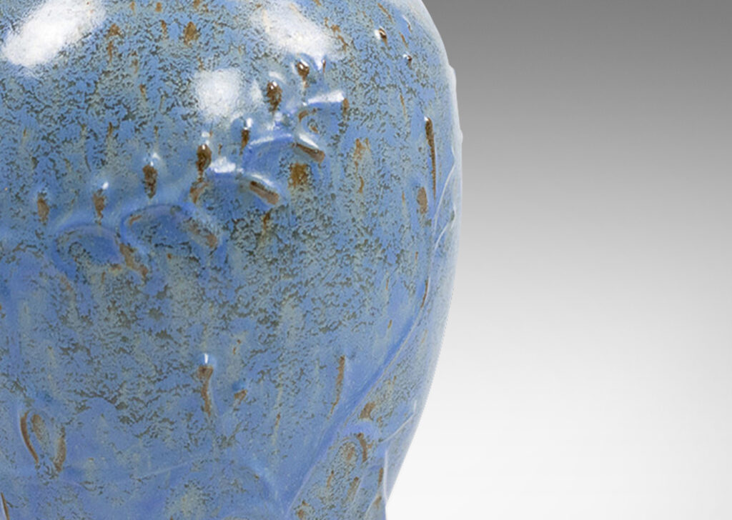 Gallery BAC swelling form with botanical reliefs in earthenware with a dappled gray-cerulean