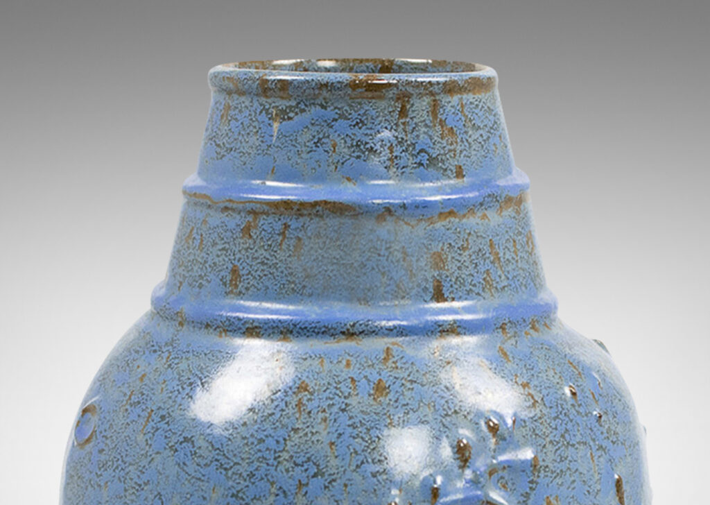 Gallery BAC swelling form with botanical reliefs in earthenware with a dappled gray-cerulean