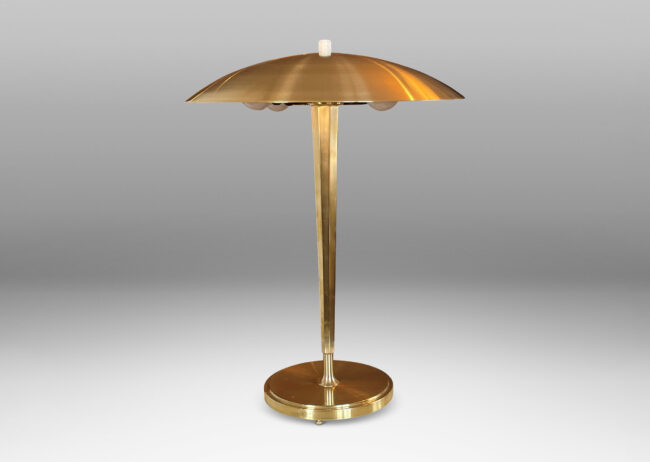 Gallery BAC tapered and octagonally faceted stand on a disk plinth with a shallow dome shade in brass