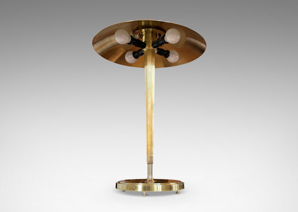 Gallery BAC tapered and octagonally faceted stand on a disk plinth with a shallow dome shade in brass