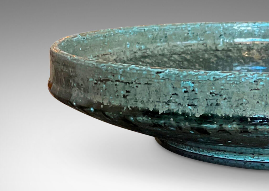 Gallery BAC wide concave form with low straight sides and a reveal foot; in grog stoneware with an olive green-gray glaze