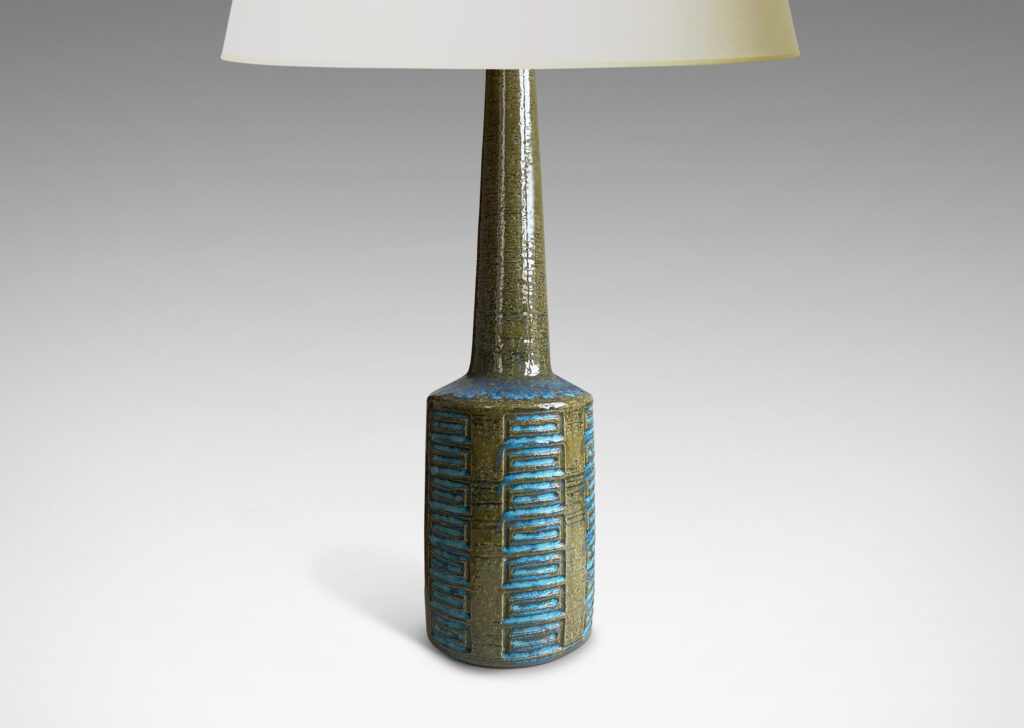 Gallery BAC cylindrical form with tall neck and pattern of carved rectangle motifs; glazed in olive green with turquoise accents