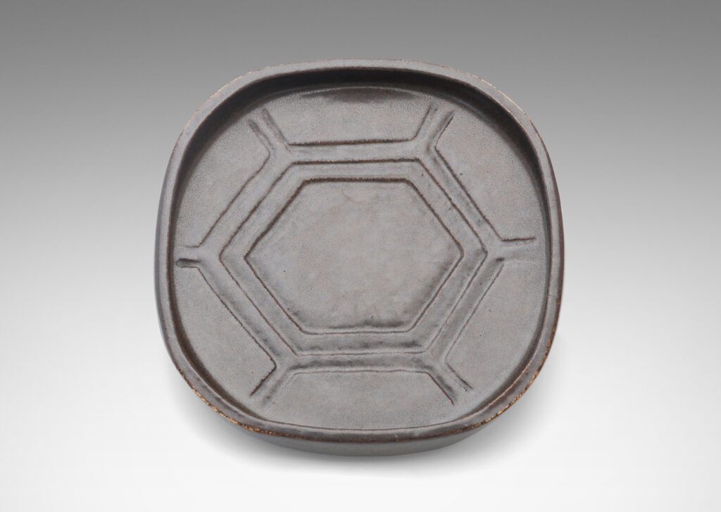 Gallary BAC rounded square form with low edges and carved hexagonal pattern in a deep ganache brown