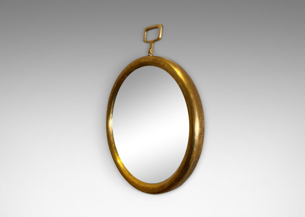 Gallery BAC round frame with rectangular loop on top in the manner of a pocket watch; brass, mirrored glass