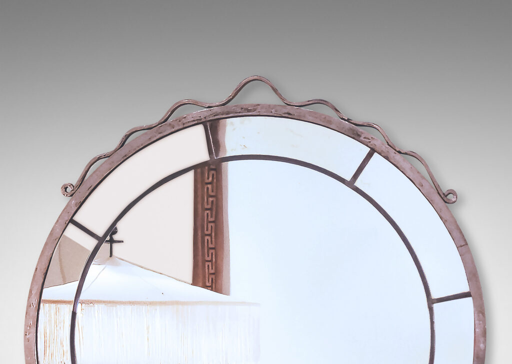 Gallery BAC central round panel framed in arc-shaped sections, set in a metal frame given a worked texture, crowned with a ribbon-like looped pediment