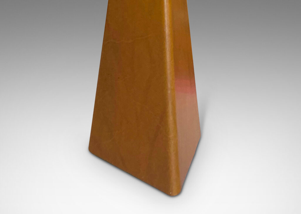 Gallery BAC three-sided triangular-faced forms in wood covered in tan leather