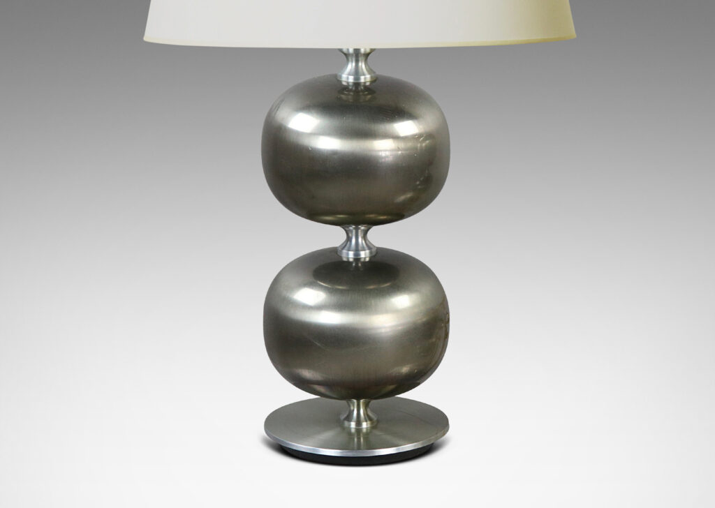 Gallery BAC bases of plump globe forms on a disk plinth in brushed steel with an iron weight