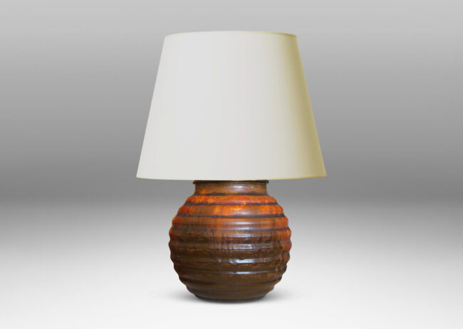 Gallery BAC a ridged globe form in flowing orange over brown glazing