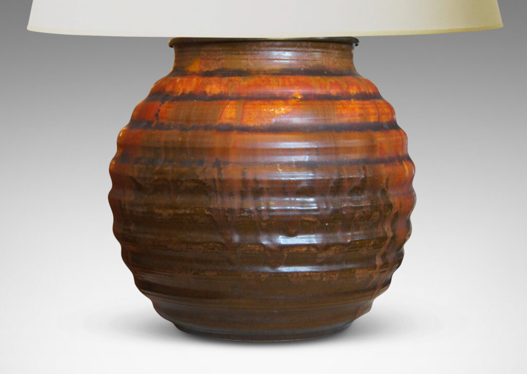 Gallery BAC a ridged globe form in flowing orange over brown glazing