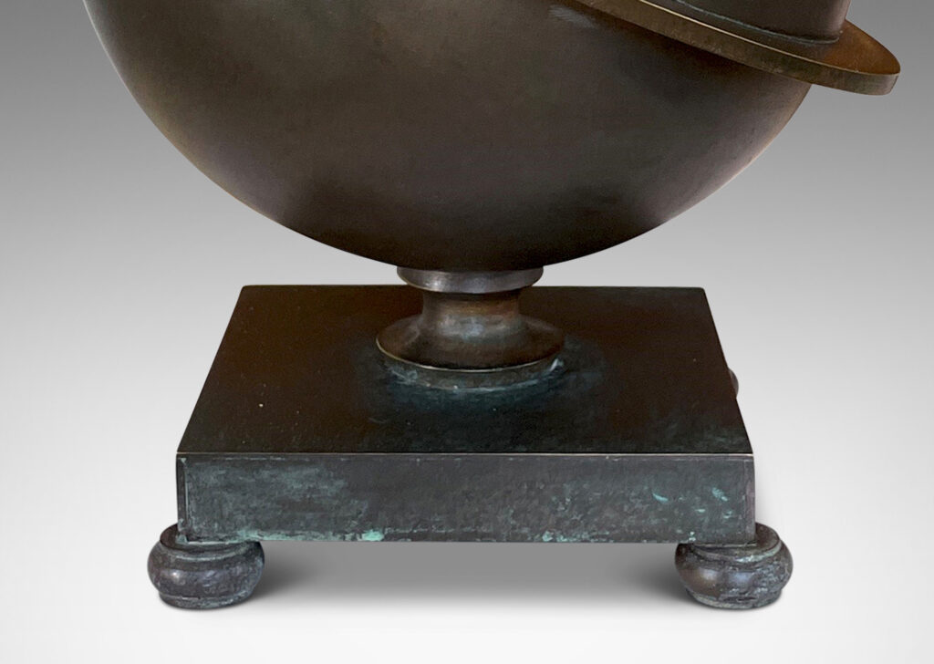 Gallery BAC Saturn-ringed globe form on a square footed base; patinated bronze