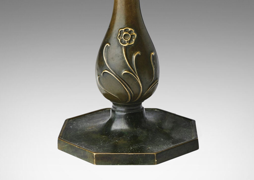 Gallery BAC bud vase form with floral relief and an octagonal plinth; patinated bronze