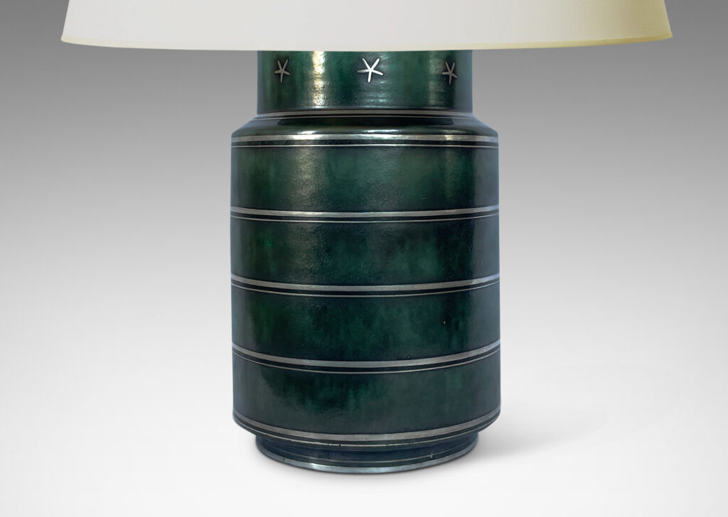 Gallery BAC cylindrical for with inset neck crafted in stoneware with a deep green-blue copper oxide glaze inlaid with stripes and stars in silver