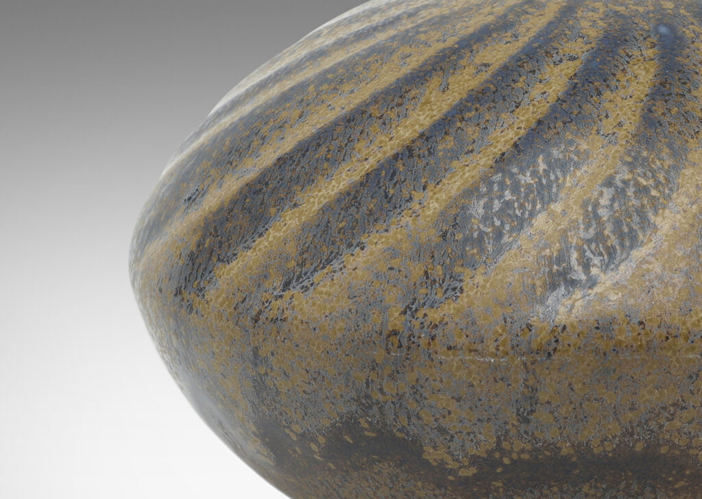 Gallery BAC discus form with carved swirling pattern, with a blue and light brown glaze