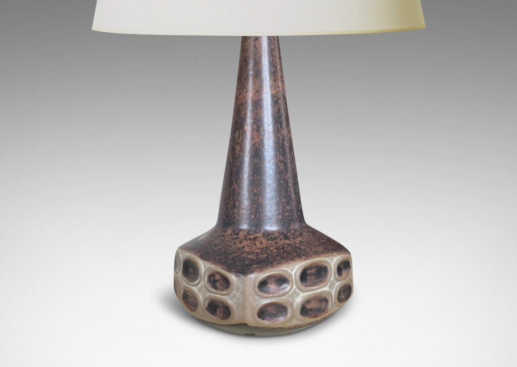 Gallery BAC organically modeled low square form with reliefs of ovals and a tall conical neck, in sponged matte dark and light brown tone glazes