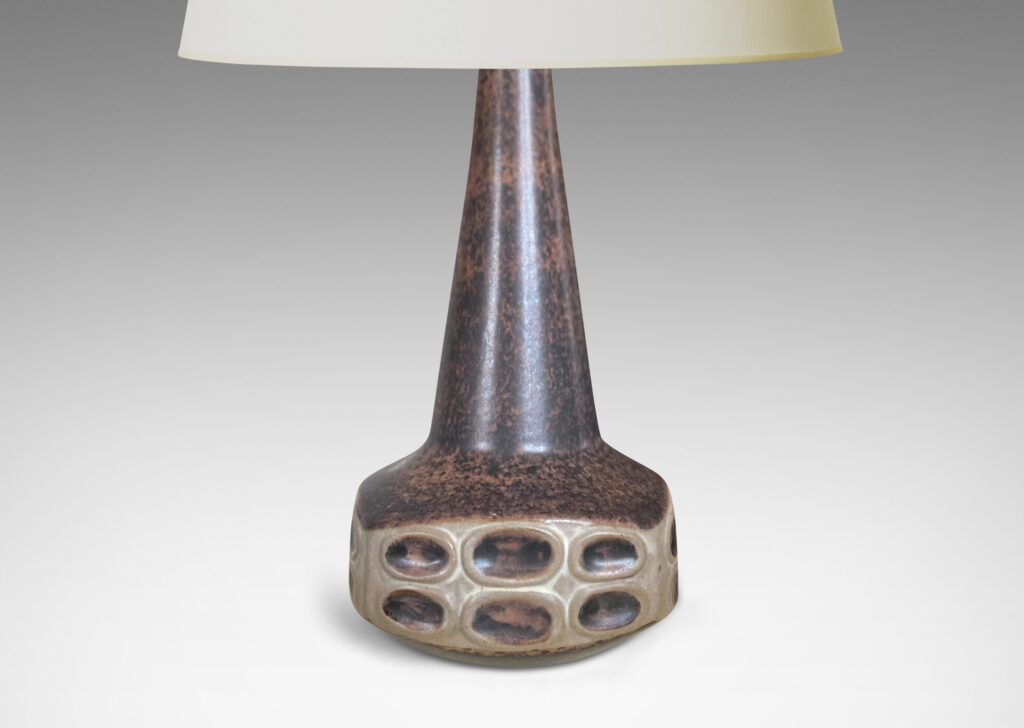 Gallery BAC organically modeled low square form with reliefs of ovals and a tall conical neck, in sponged matte dark and light brown tone glazes