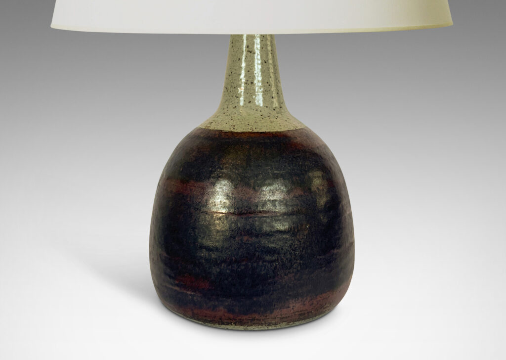 Gallery BAC bulbous form with tall, conical neck, glazed in a black and burgundy luster and speckled gray