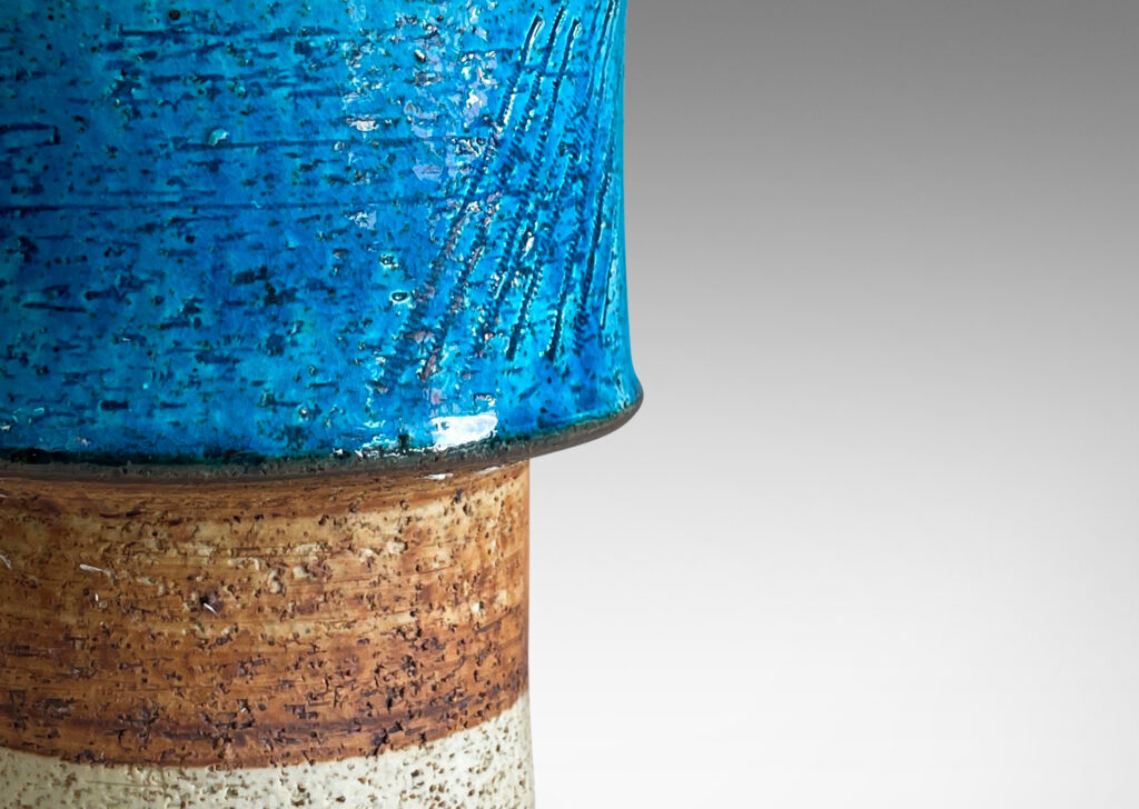 Gallery BAC stacked drum forms with a rustic grog texture, partially glazed in gloss turquoise, with matte brown accents