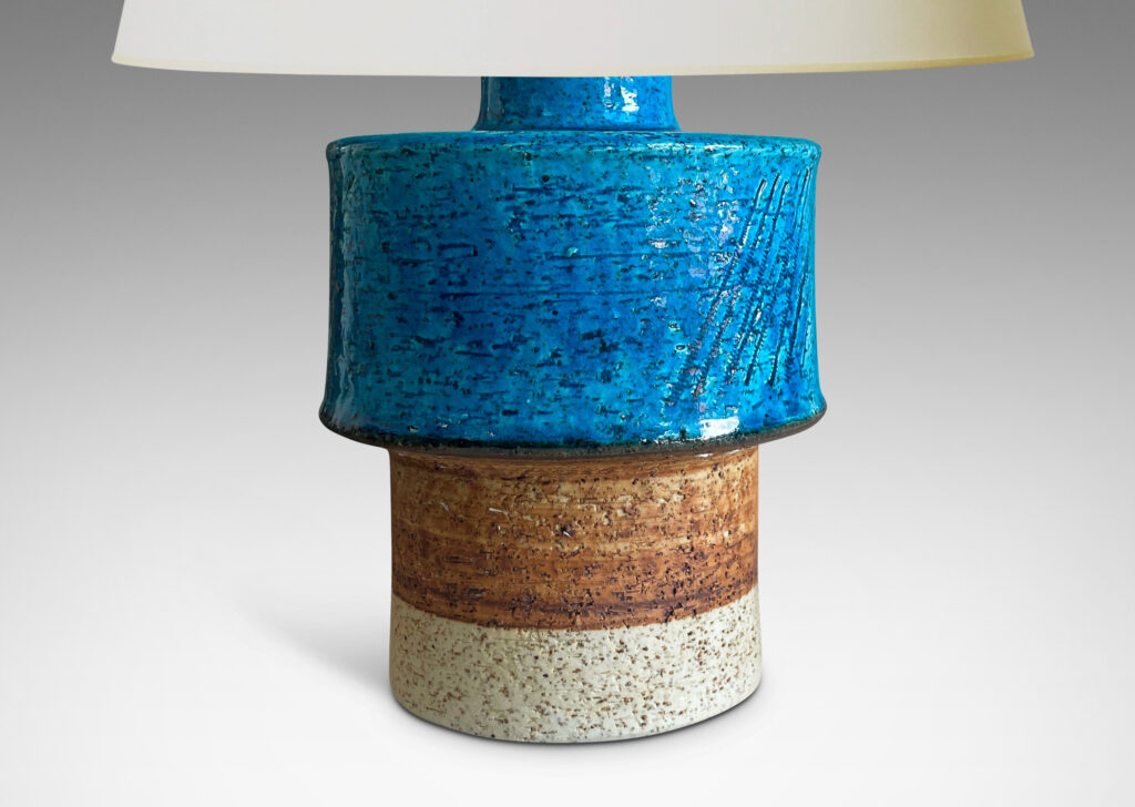 Gallery BAC stacked drum forms with a rustic grog texture, partially glazed in gloss turquoise, with matte brown accents