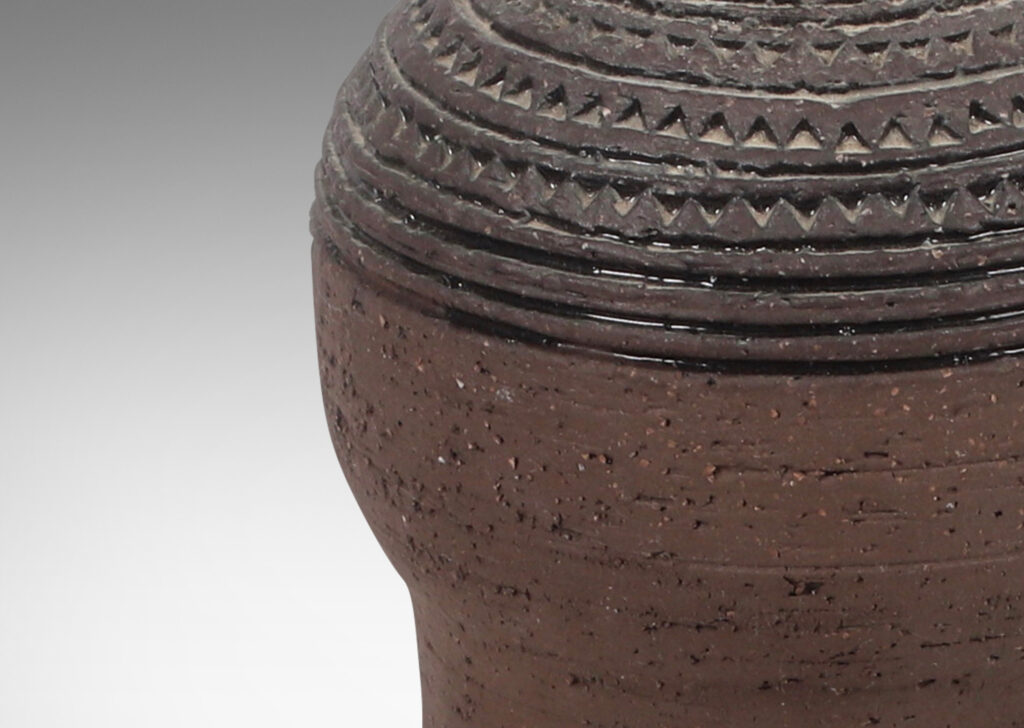 Gallery BAC globe form on a cylinder in matte brown, with rows of carved stripes and impressed triangles