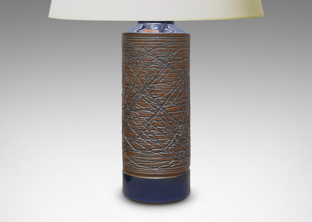 Gallery BAC cylindrical forms carved in a looping grid design and glazed a clear blue-tinted glaze