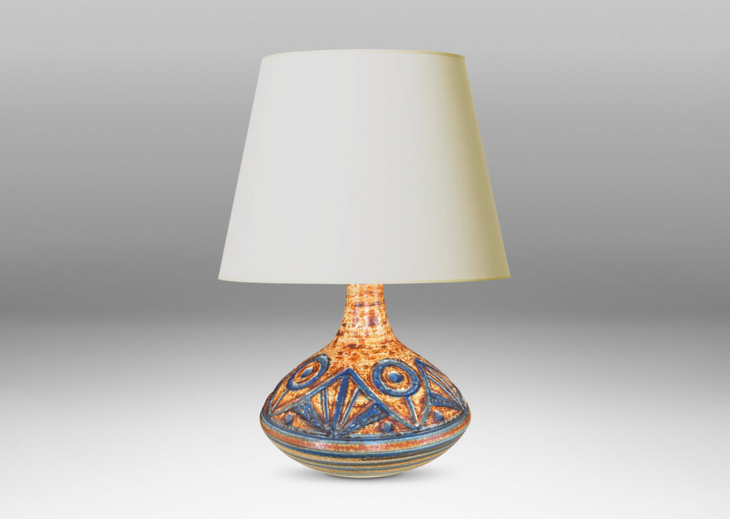 Gallery BAC angled decanter form with carved abstract floral design and stripes in mottled caramel brown with blue-gray glazing