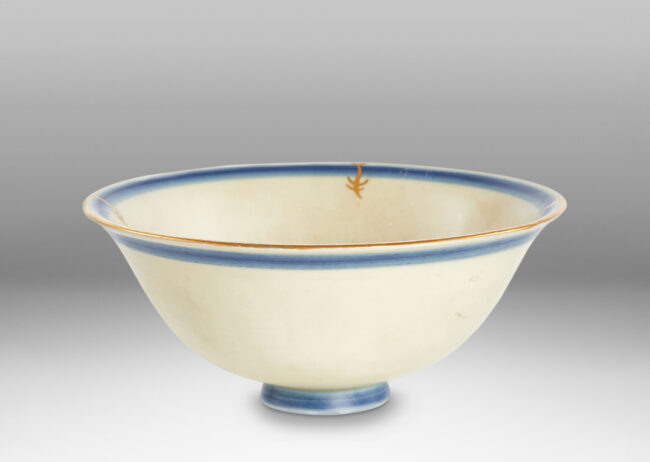 Gallery BAC classic form with flared lip in ivory glaze with soft blue lines around rim and base and gilded floral design inside and edge detail