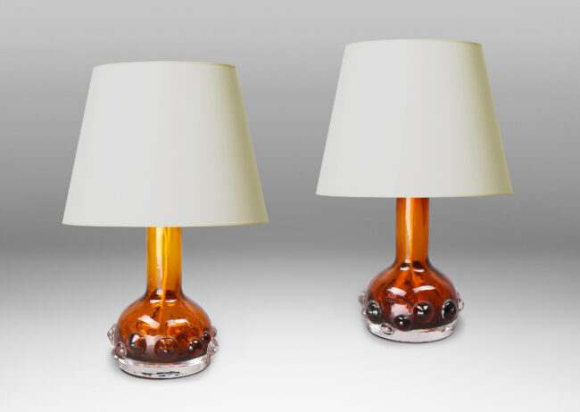 Gallery BAC decanter forms with attenuated necks and applied relief of demi-spheres in amber within clear glass