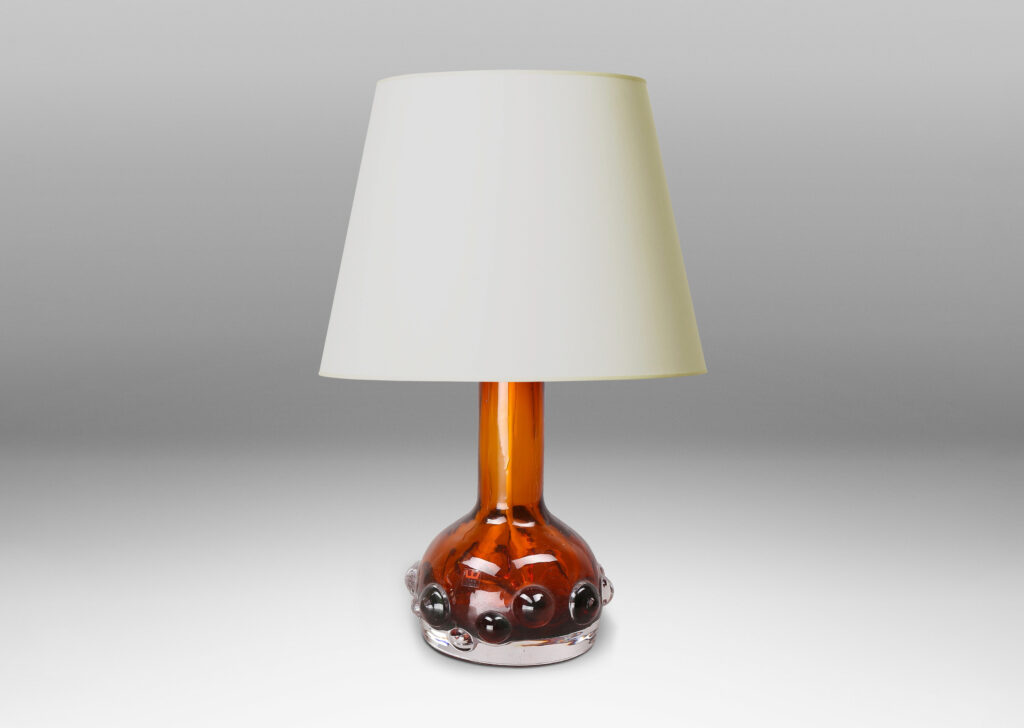 Gallery BAC decanter forms with attenuated necks and applied relief of demi-spheres in amber within clear glass