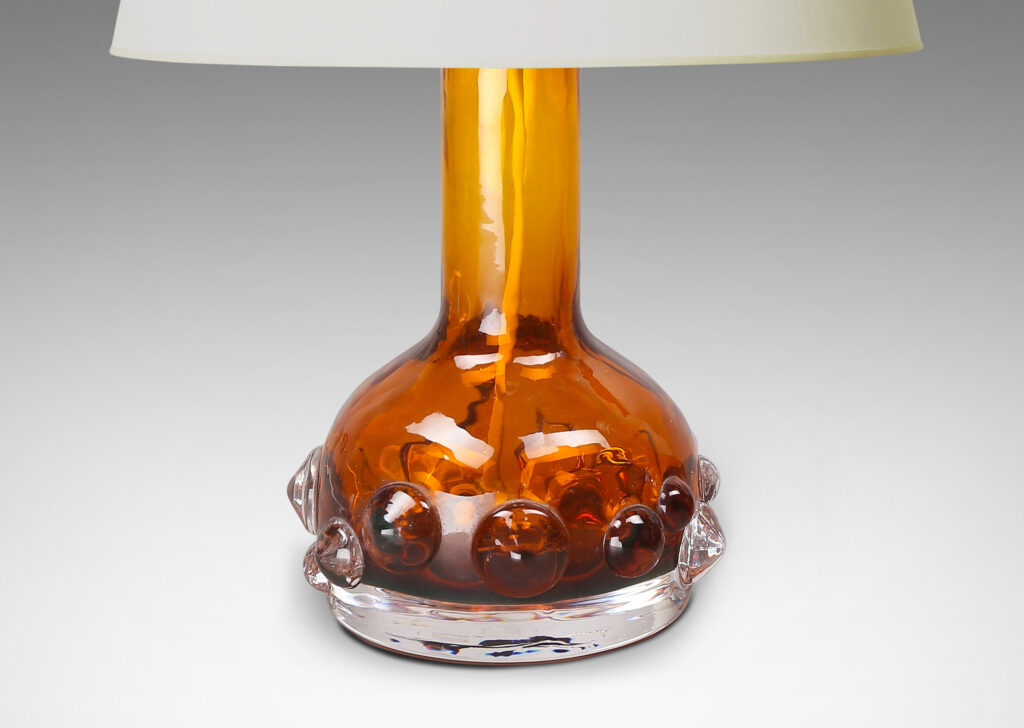 Gallery BAC decanter forms with attenuated necks and applied relief of demi-spheres in amber within clear glass