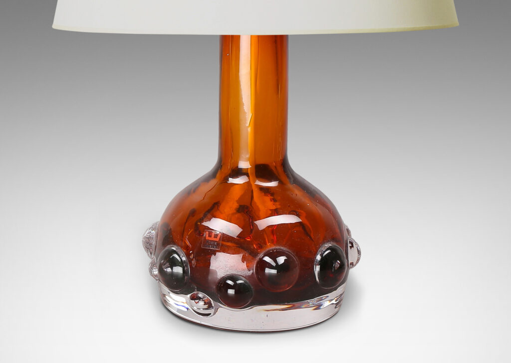 Gallery BAC decanter forms with attenuated necks and applied relief of demi-spheres in amber within clear glass