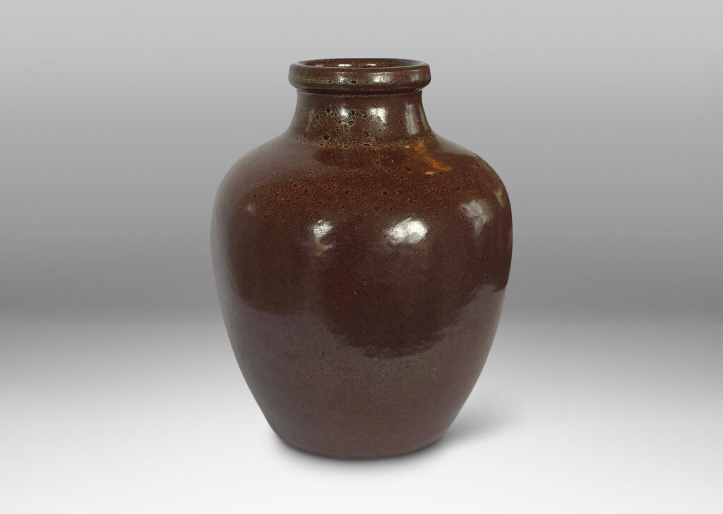 Gallery BAC tapered jug-like form with a wide neck in a saturated brown attractively constellated around the shoulder