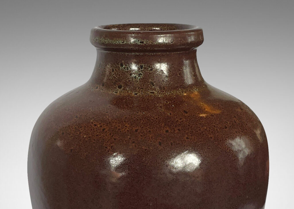 Gallery BAC tapered jug-like form with a wide neck in a saturated brown attractively constellated around the shoulder