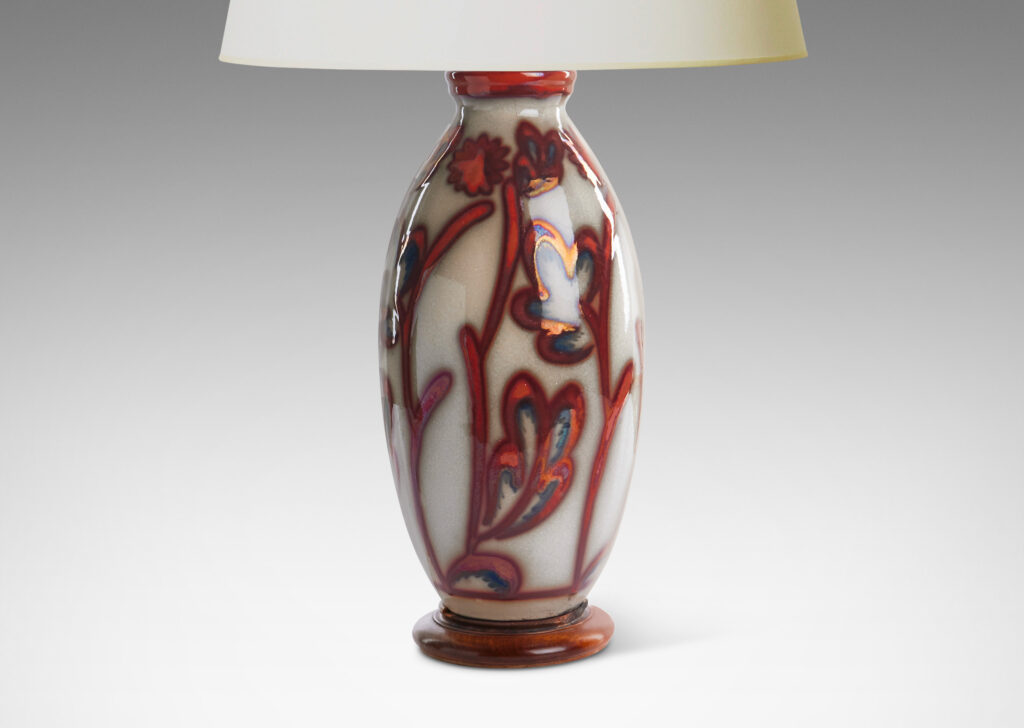 Gallery BAC swelling column form exuberantly painted with a stylized flora design in red luster on a pale gray field