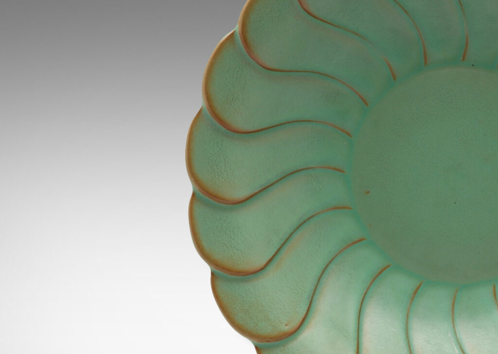 Gallery BAC relief pattern of overlapping scallops, vaguely evoking a flower, in a bright celadon with brown shading